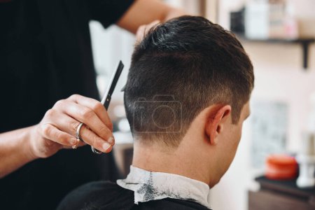 Photo for Master hairdresser does hairstyle with scissors and comb. - Royalty Free Image