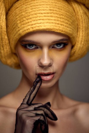 Photo for Beauty blonde model girl with fashionable creative make-up, bright eye line wear yellow turban. Creative eye makeup ideas. - Royalty Free Image