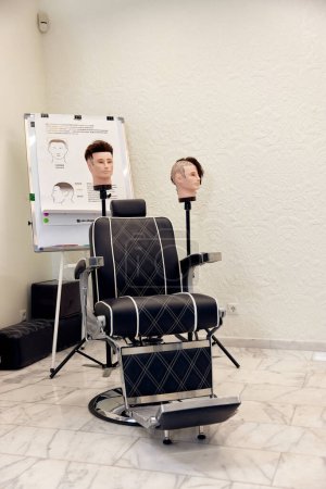 Téléchargez les photos : Dnipro, Ukraine, December 3, 2022: Clients stylish barber chair and training mannequins in barber shop. - en image libre de droit