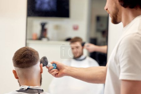 Photo for Barber holding brush for talco in barber shop. close-up - Royalty Free Image