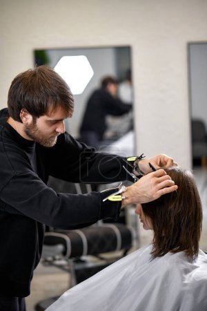 Photo for Male hairdresser working with client at the beauty salon - Royalty Free Image
