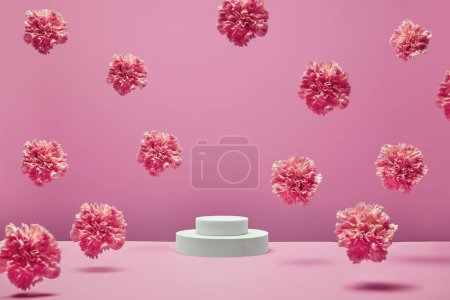 Photo for White round podium for presentation products and cosmetics with fresh pastel flowers flying in the air on pink background. - Royalty Free Image