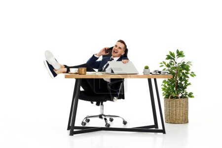 Photo for Successful happy businessman working with laptop and having phone conversation with client - Royalty Free Image