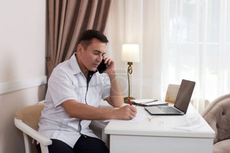 Photo for Male doctor in white medical uniform using computer laptop in health clinic or hospital. online consultation for domestic health treatment - Royalty Free Image
