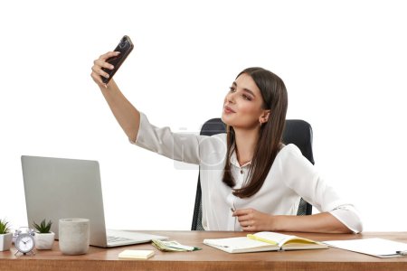 Photo for Happy beautiful young woman takes selfie in office - Royalty Free Image