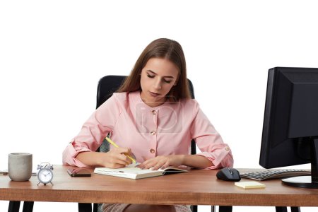 Photo for Business woman in pink shirt taking notes in office - Royalty Free Image