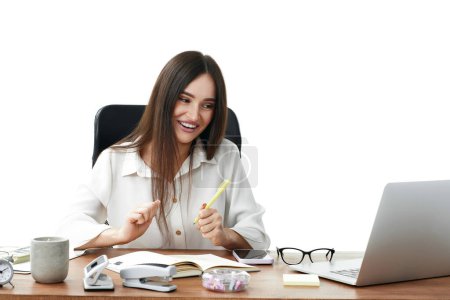 Photo for Beautiful businesswoman talking on video call to client, sitting on chair at desk, using laptop - Royalty Free Image