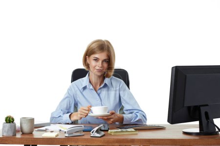 Téléchargez les photos : Heureuse belle femme d'affaires blonde en utilisant un ordinateur PC, boire du café dans le bureau - en image libre de droit