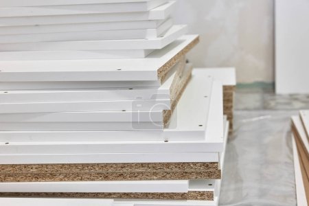 Photo for Stack of white MDF panels lie on floor. Construction material. - Royalty Free Image