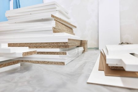 Photo for Stack of white MDF panels lie on floor. Construction material. - Royalty Free Image
