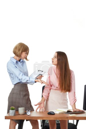 Photo for Two pretty business woman discuss financial statistics and investment market in office. conflict at workplace - Royalty Free Image