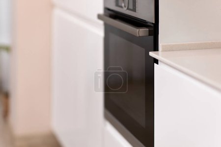 Photo for Black oven in modern white kitchen, copy space - Royalty Free Image