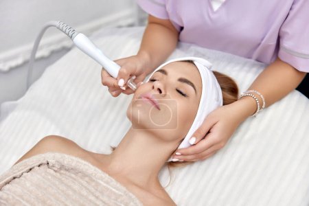 Photo for Beautiful woman getting microdermabrasion procedure in a beauty spa salon - Royalty Free Image