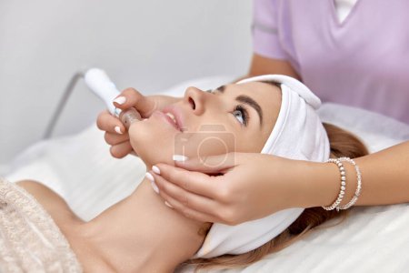 Photo for Beautiful woman getting microdermabrasion procedure in a beauty spa salon - Royalty Free Image