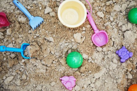 Foto de Caja de arena para niños con varios juguetes para el juego en el día de verano - Imagen libre de derechos