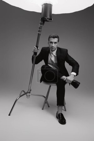 Photo for Elegant model man in black suit in photostudio. black and white - Royalty Free Image
