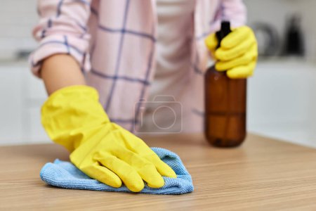 Photo for Female hands cleaning wooden table with microfiber cloth. close-up. Housekeeping - Royalty Free Image