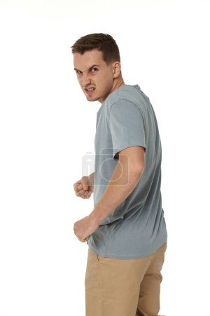 Photo for Annoyed angry man standing on white studio background - Royalty Free Image