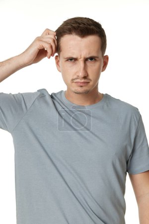 Photo for Offended frustrated young man on white background. sadness - Royalty Free Image