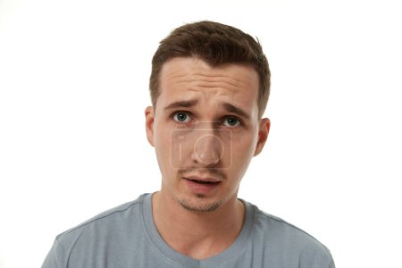 Photo for Portrait of offended young man on white background. sadness - Royalty Free Image