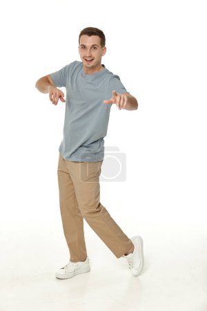 Photo for Happy guy looking pointing at the camera on white studio background - Royalty Free Image