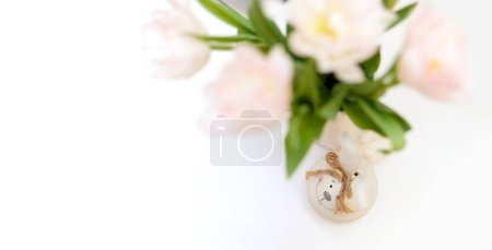 Photo for Bouquet of tulips and Easter bunny on white table. copy space - Royalty Free Image