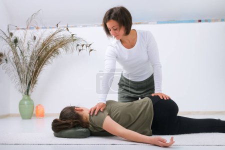 Photo for Teenager getting Shiatsu massage from Shiatsu masseuse - Royalty Free Image