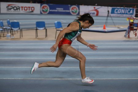 Photo for ISTANBUL, TURKEY - MARCH 05, 2022: Undefined athlete running 60 metres during Balkan Athletics Indoor Championships in Atakoy Athletics Arena - Royalty Free Image