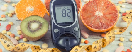 Photo for Glucometer for checking sugar level, fresh natural fruits and medical pills. Choice between eating fruits and taking supplements during diabetes - Royalty Free Image