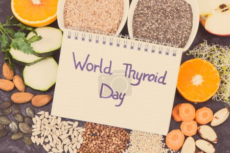 Notepad with inscription World Thyroid Day and best nutritious ingredients for healthy thyroid