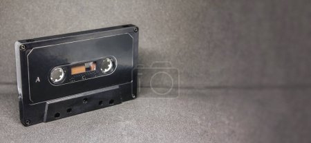 Foto de Retro audio cassette, tape on a grey background. music concept - Imagen libre de derechos