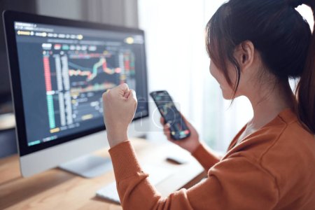 Photo for Close up - woman excited about victory after cryptocurrency future price action prediction. Female is checking Bitcoin price chart on digital exchange on smartphone - Royalty Free Image