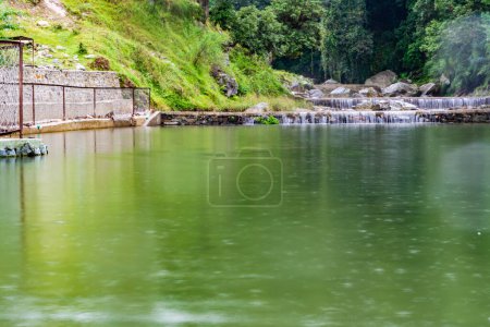 small waterfall with a small lake near Bhimtal. Landscape view of a small waterfall in the mountains. crystalline waterfall.