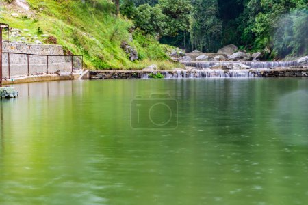 small waterfall with a small lake near Bhimtal. Landscape view of a small waterfall in the mountains. crystalline waterfall.