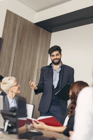 Photo for Business team on a morning briefing; business meeting and presentation in a modern office - Royalty Free Image