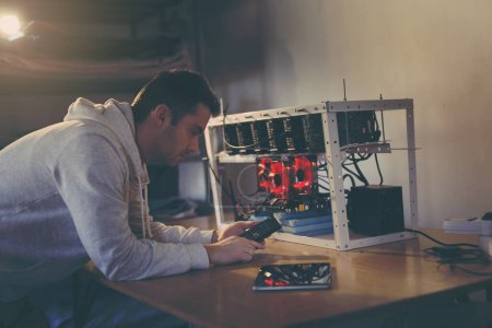Photo for Programmer setting up a mining rig for cryptocurrency mining - Royalty Free Image