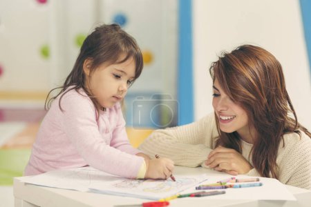 Photo for Mother and daughter drawing together. Focus on the daughter - Royalty Free Image