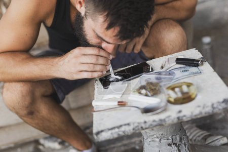 Foto de Drogadicto olfatear la línea de heroína con un billete de dólar enrollado de una pantalla de teléfono inteligente - Imagen libre de derechos