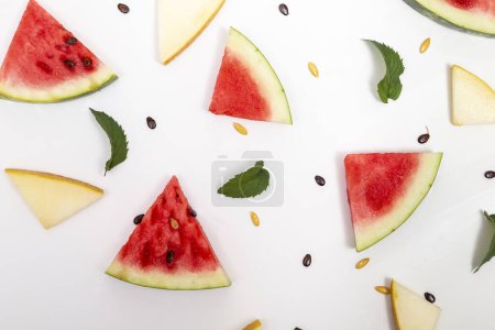 Photo for Top view of watermelon and melon pieces, mint leaves and watermelon and melon seeds isolated on white background - Royalty Free Image