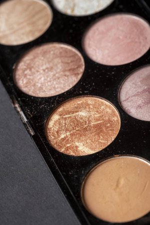 Photo for High angle view of a make up highlighters palette with pinkish and beige tones. Selective focus - Royalty Free Image