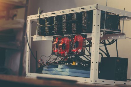 Photo for Mining rig for cryptocurrency digging set up and operational. Selective focus on the GPU - Royalty Free Image