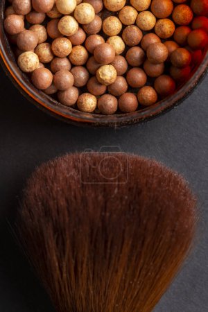 Photo for Table top shot of face powder pearls in an open powder box and a make up brush. Feminine cosmetics and make up product, bronzer and blusher - Royalty Free Image