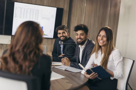 Photo for Business woman on a job interview with three human resources representatives as a board members. Focus on the man in the middle - Royalty Free Image