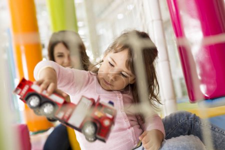 Photo for Little girl and her mother playing in a playroom and having fun - Royalty Free Image