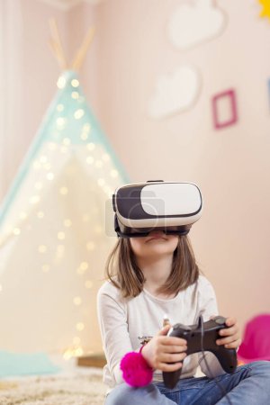 Foto de Niña con auriculares de realidad virtual, jugando videojuegos en una sala de juegos y divirtiéndose - Imagen libre de derechos