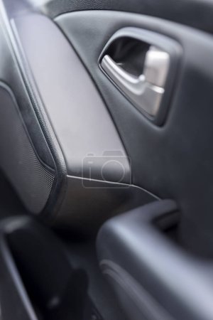 Photo for Close up detail of a car interior - part of the car door with the opening handle - Royalty Free Image
