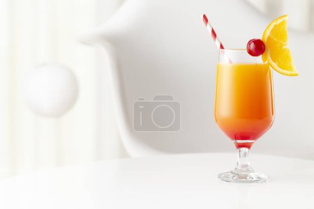 Photo for Cold tequila sunrise cocktail with tequila, pomegranate juice and orange juice decorated with slices of orange and maraschino cherries. Focus on the cherry on the glass - Royalty Free Image