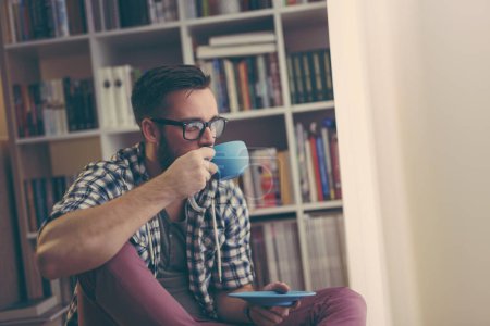 Photo for Relaxed man enjoying his first morning coffee at home - Royalty Free Image