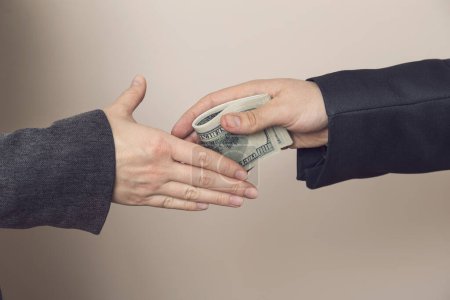 Photo for Detail of two business people sealing the deal with bribe money. Selective focus - Royalty Free Image