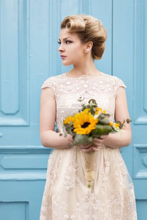 Photo for Portrait of a beautiful bride in a wedding dress, holding a sunflower wedding bouquet - Royalty Free Image